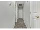 Bright hallway with tile flooring and white doors leading to various rooms at 3122 E Windmere Dr, Phoenix, AZ 85048
