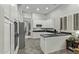 Open kitchen featuring white cabinets, dark countertops, stainless steel appliances and tile flooring at 3122 E Windmere Dr, Phoenix, AZ 85048