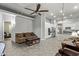 Spacious living room featuring neutral paint, ceiling fan, and tile flooring throughout the home at 3122 E Windmere Dr, Phoenix, AZ 85048