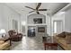 Living room featuring a ceiling fan, stone fireplace and built-in workspace at 3122 E Windmere Dr, Phoenix, AZ 85048