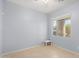 Bright bedroom with tile flooring and a window at 42356 W Balsa Dr, Maricopa, AZ 85138