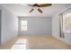 Bright bedroom with tile floors and ceiling fan at 42356 W Balsa Dr, Maricopa, AZ 85138