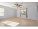 Spacious bedroom with tile floors and ceiling fan at 42356 W Balsa Dr, Maricopa, AZ 85138