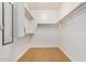 Spacious walk-in closet with built-in shelving and rods at 42356 W Balsa Dr, Maricopa, AZ 85138