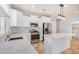 Modern kitchen with white cabinets, stainless steel appliances, and an island at 42356 W Balsa Dr, Maricopa, AZ 85138