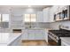 Modern kitchen with white cabinets and stainless steel appliances at 42356 W Balsa Dr, Maricopa, AZ 85138
