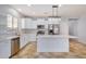 Modern kitchen with white cabinets, stainless steel appliances, and an island at 42356 W Balsa Dr, Maricopa, AZ 85138