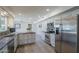 Bright kitchen featuring stainless steel appliances, custom cabinets and decorative backsplash at 9422 W Country Club Dr, Sun City, AZ 85373