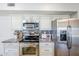 Stainless steel oven and refrigerator with custom cabinets at 9422 W Country Club Dr, Sun City, AZ 85373