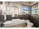 Contemporary bathroom with a unique vanity, modern fixtures, and a stylish mirror and lighting at 40575 N 109Th Pl, Scottsdale, AZ 85262