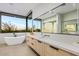 Bright bathroom featuring a soaking tub, large mirrors, and double vanities for a spa-like experience at 40575 N 109Th Pl, Scottsdale, AZ 85262