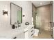 Modern bathroom featuring glass enclosed shower, white countertop, black fixtures, blending style and function at 40575 N 109Th Pl, Scottsdale, AZ 85262