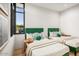 Comfortable bedroom featuring two twin beds with green headboards and decorative throw pillows and side tables at 40575 N 109Th Pl, Scottsdale, AZ 85262