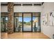 Grand foyer with stone accent wall, light wood floors and a large window showcasing outdoor view at 40575 N 109Th Pl, Scottsdale, AZ 85262
