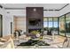 Chic living room featuring a modern fireplace, stylish furniture, and floor to ceiling windows at 40575 N 109Th Pl, Scottsdale, AZ 85262