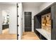 Functional mudroom with storage, a bench, and a door leading to the rest of the house at 40575 N 109Th Pl, Scottsdale, AZ 85262