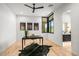 Bright office space featuring hardwood floors, modern black desk, and natural light from a large window at 40575 N 109Th Pl, Scottsdale, AZ 85262