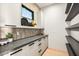 Well-organized pantry with ample shelving, white cabinets, and a contrasting gray countertop at 40575 N 109Th Pl, Scottsdale, AZ 85262