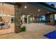 Expansive patio featuring stone accents, large sliding doors, and a built-in firepit with stunning views at 40575 N 109Th Pl, Scottsdale, AZ 85262