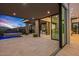 Luxury patio with stone pillars, built in hot tub, desert views, and sliding glass doors to the main residence at 40575 N 109Th Pl, Scottsdale, AZ 85262