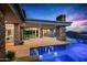 Beautiful pool area adjacent to a modern home featuring an outdoor fireplace and inviting lounge area for relaxation at 40575 N 109Th Pl, Scottsdale, AZ 85262