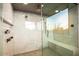 A luxurious shower offers dual shower heads, a built-in bench, and a glass enclosure for a spa-like feel at 40575 N 109Th Pl, Scottsdale, AZ 85262