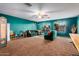 Large bonus room with a comfortable seating area and teal walls at 62 W Elmwood Pl, Chandler, AZ 85248