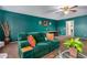 Bonus room featuring a green couch, a ceiling fan, and large windows at 62 W Elmwood Pl, Chandler, AZ 85248