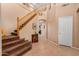 Bright entryway with staircase, tile flooring, and a wooden railing at 62 W Elmwood Pl, Chandler, AZ 85248