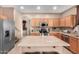 Kitchen with an island, stainless steel appliances, and light wood cabinets at 62 W Elmwood Pl, Chandler, AZ 85248