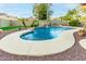 Kidney shaped pool with waterfall at 62 W Elmwood Pl, Chandler, AZ 85248