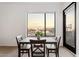 Dining area with a table set, views of the city skyline, and an adjacent doorway at 1130 N 2Nd St # 409, Phoenix, AZ 85004