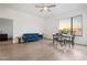 Open living room with hardwood floors, a blue sofa, dining table, and a large window with city views at 1130 N 2Nd St # 409, Phoenix, AZ 85004