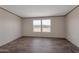 Bright bedroom featuring two windows offering beautiful desert views at 52089 W Organ Pipe Rd, Maricopa, AZ 85139