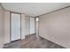 Bedroom featuring wood-look floors, closet, and natural light at 52089 W Organ Pipe Rd, Maricopa, AZ 85139