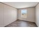 Bedroom featuring modern wood-look floors and natural light with a view at 52089 W Organ Pipe Rd, Maricopa, AZ 85139