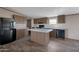 Spacious kitchen features black appliances, island, and stylish wood cabinets at 52089 W Organ Pipe Rd, Maricopa, AZ 85139