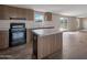 The kitchen features ample counter space, modern appliances, and luxury vinyl flooring at 52089 W Organ Pipe Rd, Maricopa, AZ 85139