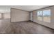 Bright living room with vinyl flooring and ample natural light from large windows at 52089 W Organ Pipe Rd, Maricopa, AZ 85139