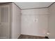 A simple utility room with a single shelf and white walls offers a basic storage solution at 52089 W Organ Pipe Rd, Maricopa, AZ 85139