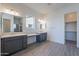 Double vanity bathroom with grey cabinets and quartz countertops at 16405 W Desert Mirage Dr, Surprise, AZ 85388