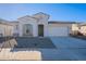 One-story home with white exterior, gray shutters, and a two-car garage at 16405 W Desert Mirage Dr, Surprise, AZ 85388