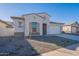 New construction home with a landscaped front yard and neutral color palette at 16405 W Desert Mirage Dr, Surprise, AZ 85388