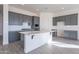 Modern kitchen with gray cabinets, white subway tile backsplash, and quartz countertops at 16405 W Desert Mirage Dr, Surprise, AZ 85388