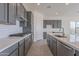 Modern kitchen with gray shaker cabinets and a large kitchen island at 16405 W Desert Mirage Dr, Surprise, AZ 85388