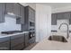 Kitchen with gray cabinets, white subway tile, and stainless steel appliances at 16405 W Desert Mirage Dr, Surprise, AZ 85388