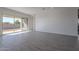 Living area with tile floors and sliding glass doors leading to the backyard at 16405 W Desert Mirage Dr, Surprise, AZ 85388