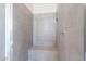 Walk-in shower with tile surround and built in seat at 16405 W Desert Mirage Dr, Surprise, AZ 85388