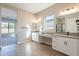 Spacious bathroom with double vanity, large mirror, and walk-in shower at 16430 W Desert Mirage Dr, Surprise, AZ 85388