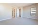 Well-lit bedroom with window and door to bathroom at 16430 W Desert Mirage Dr, Surprise, AZ 85388